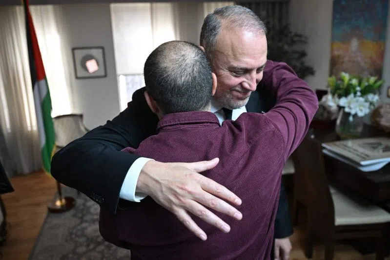 Head of the Palestine Mission to the UK, Husam Zomlot (R) embraces members of staff after watching a television broadcast of Britain's Prime Minister Keir Starmer formally recognising The Palestinian State on September 21, 2025 at their Mission in west London. Britain was set Sunday to recognise a Palestinian state with a landmark announcement due from Prime Minister Keir Starmer, as several nations were poised to follow at UN talks to pressure Israel over the Gaza war.