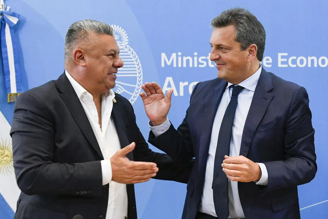 Argentine Football Association president Claudio Tapia (left) and Economy Minister Sergio Massa after signing the permits to host the U-20 World Cup in Buenos Aires.