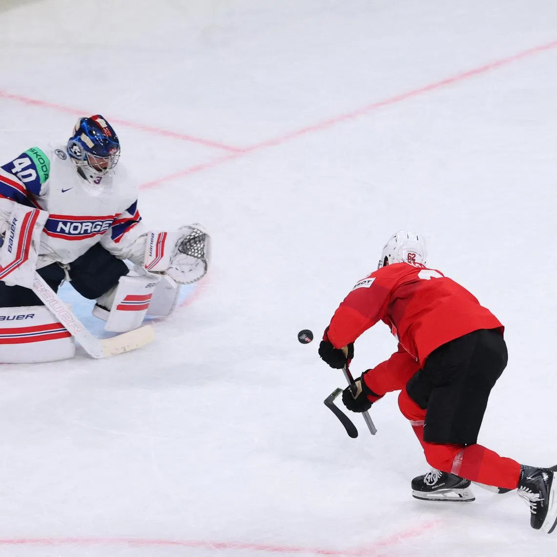 Ice Hockey - IIHF World Championships - Semi Final - Switzerland v Norway - Swiss Life Arena, Zurich, Switzerland - May 30, 2026 Switzerland's Denis Malgin shoots at goal REUTERS/Denis Balibouse
