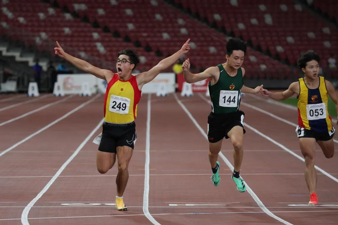Jonathan Hoare (left), of Hwa Chong Institution, celebrating his win in the A Division boys' 100m final, during the National School Games at the National Stadium on April 15.
