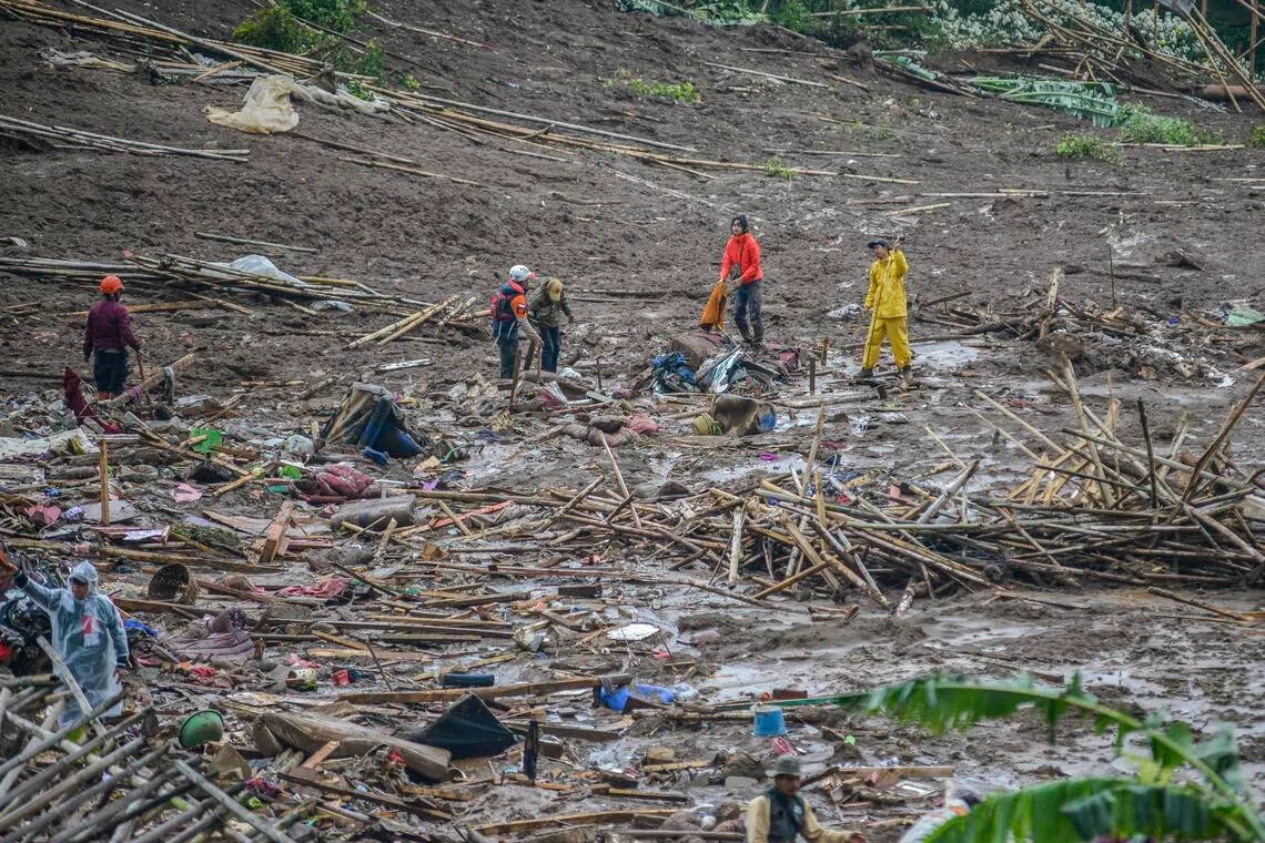 Rescuers search for victims at a landslide affected area in Pasirlangu village, West Bandung in Indonesia on Jan 24.