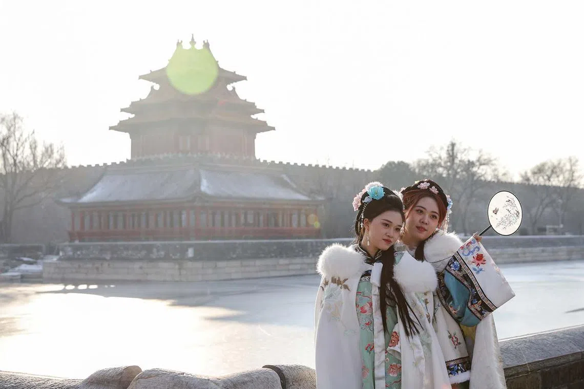 Tourists posing for a photo near the Turret of Palace Museum in Beijing, China, Dec 28, 2023. 