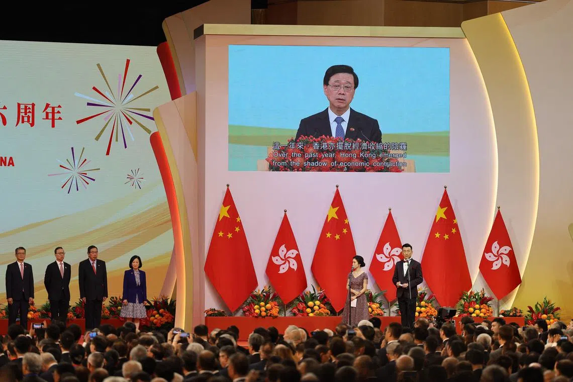 Hong Kong chief executive John Lee is seen on a giant screen as he speaks during an event celebrating the 26th anniversary of the city’s handover from Britain to China in Hong Kong on July 1, 2023. 