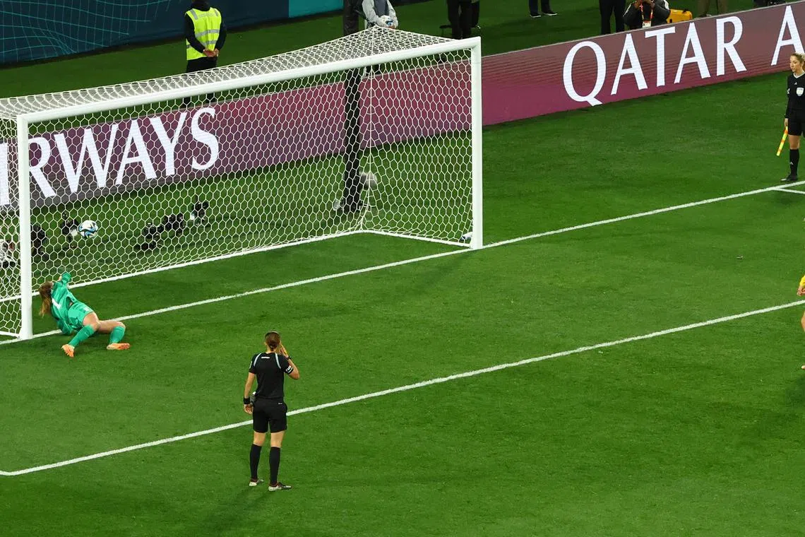 Alyssa Naeher of the US attempts to save a penalty from Sweden's Lina Hurtig during the penalty shoot-out as the ball just crosses the line.