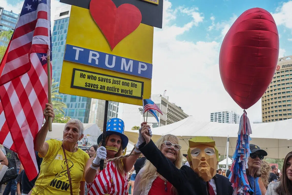 Israelis holding up a placard thanking US President Donald Trump following the announcement of a new Gaza ceasefire deal, in Tel Aviv on Oct 9.