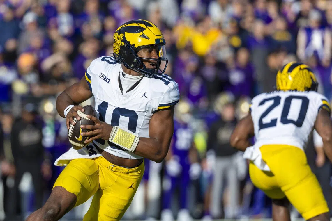FILE PHOTO: Oct 5, 2024; Seattle, Washington, USA; Michigan Wolverines quarterback Alex Orji (10) looks to pass against the Washington Huskies during the first quarter at Alaska Airlines Field at Husky Stadium. Mandatory Credit: Joe Nicholson-Imagn Images/File Photo