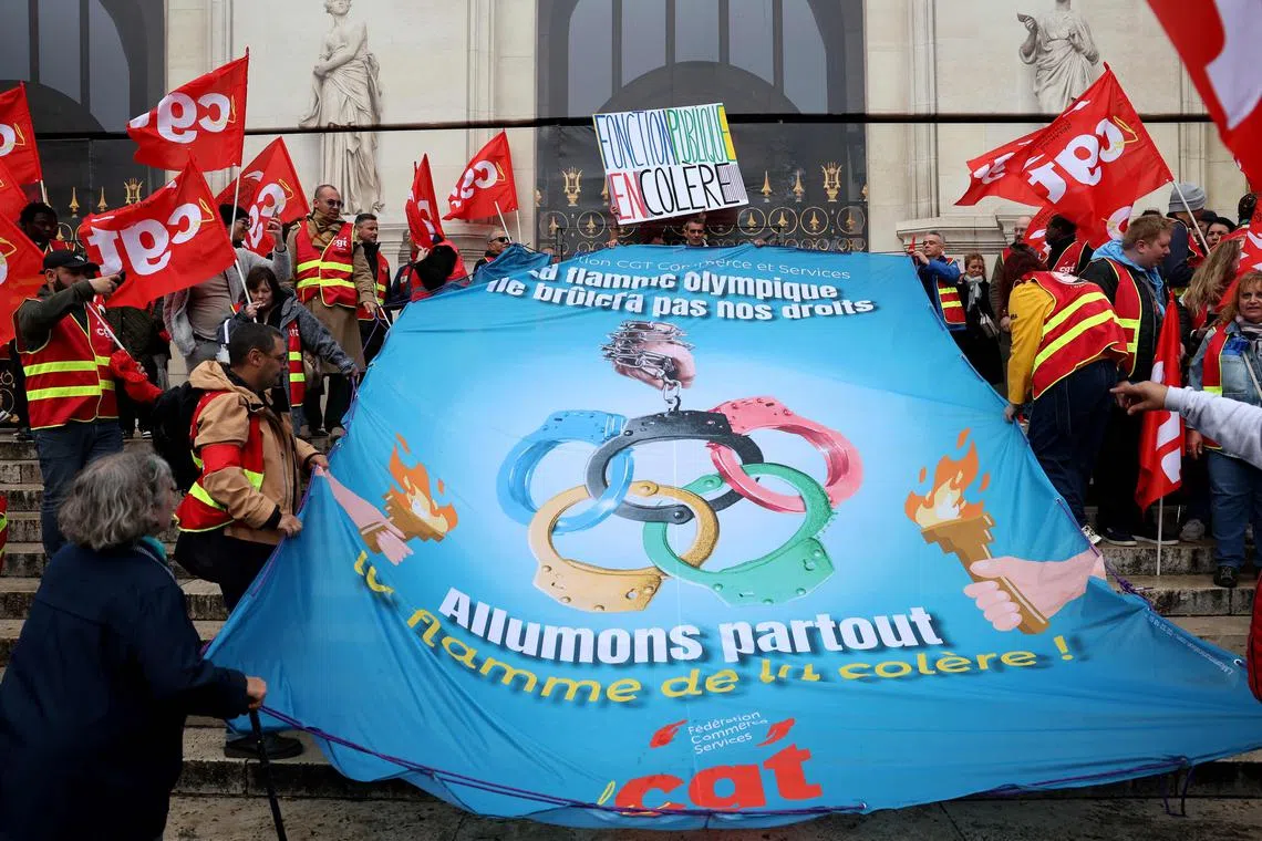 Members of the labour union CGT Commerce and Services protest about the working conditions during the upcoming Paris 2024 Olympic Games, in central Paris on April 15, 2024.