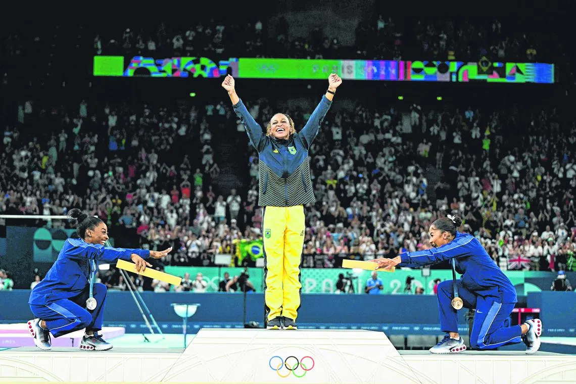 (From left to right): United States' Simone Biles (silver), Brazil's Rebeca Andrade (gold) and US' Jordan Chiles (bronze) pose during the podium ceremony for the artistic gymnastics women's floor exercise .