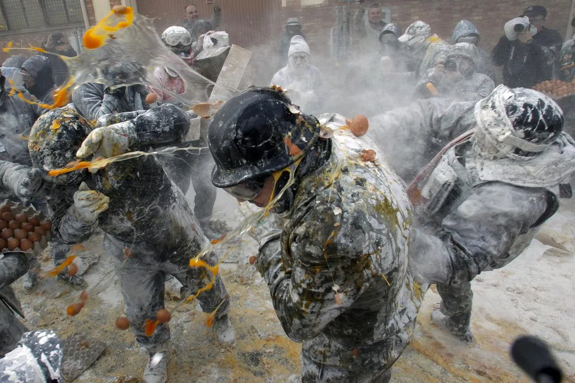 People dressed in miltary costumes taking part in a fake coup d'etat performances during the traditional fest called 'The floured ones' (Els Enfarinats) held in the village of Ibi, Alicante, Spain, Dec 28, 2023. 