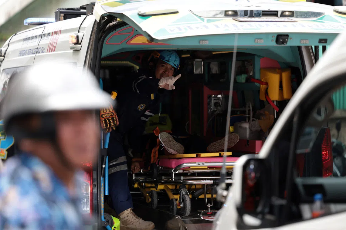 An injured person lying in an ambulance outside the Debsirin Nonthaburi School on Aug 7.