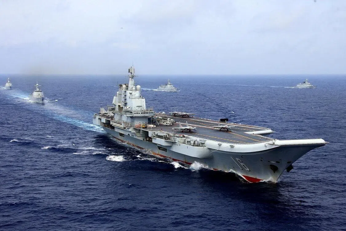 FILE PHOTO: China's aircraft carrier Liaoning takes part in a military drill of Chinese People's Liberation Army (PLA) Navy in the western Pacific Ocean, April 18, 2018. Picture taken April 18, 2018. REUTERS/Stringer ATTENTION EDITORS - THIS IMAGE WAS PROVIDED BY A THIRD PARTY. CHINA OUT.     TPX IMAGES OF THE DAY/File Photo