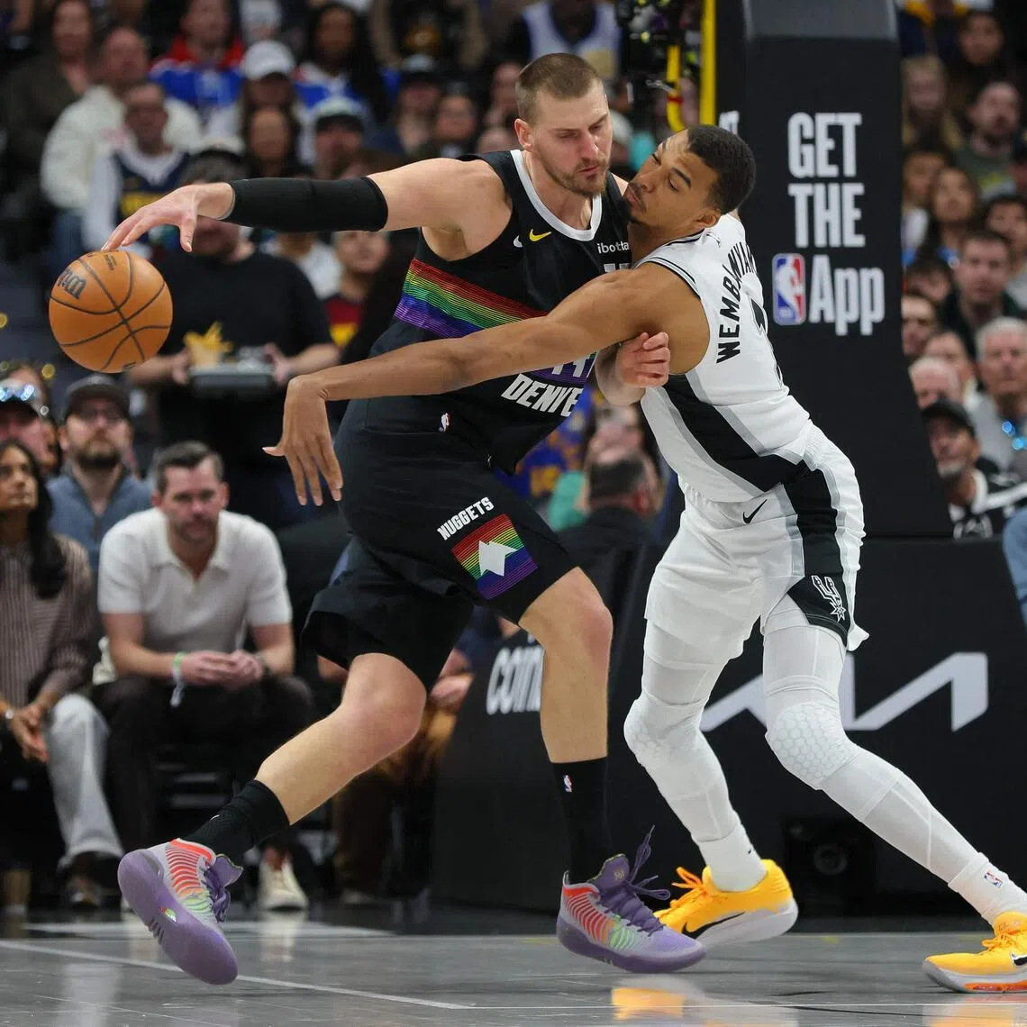 Nikola Jokic (left) and Victor Wembanyama of the San Antonio Spurs battling for the ball during the Denver Nuggets' 136-134 overtime NBA victory at Ball Arena on April 4, 2026, in Denver, Colorado.
