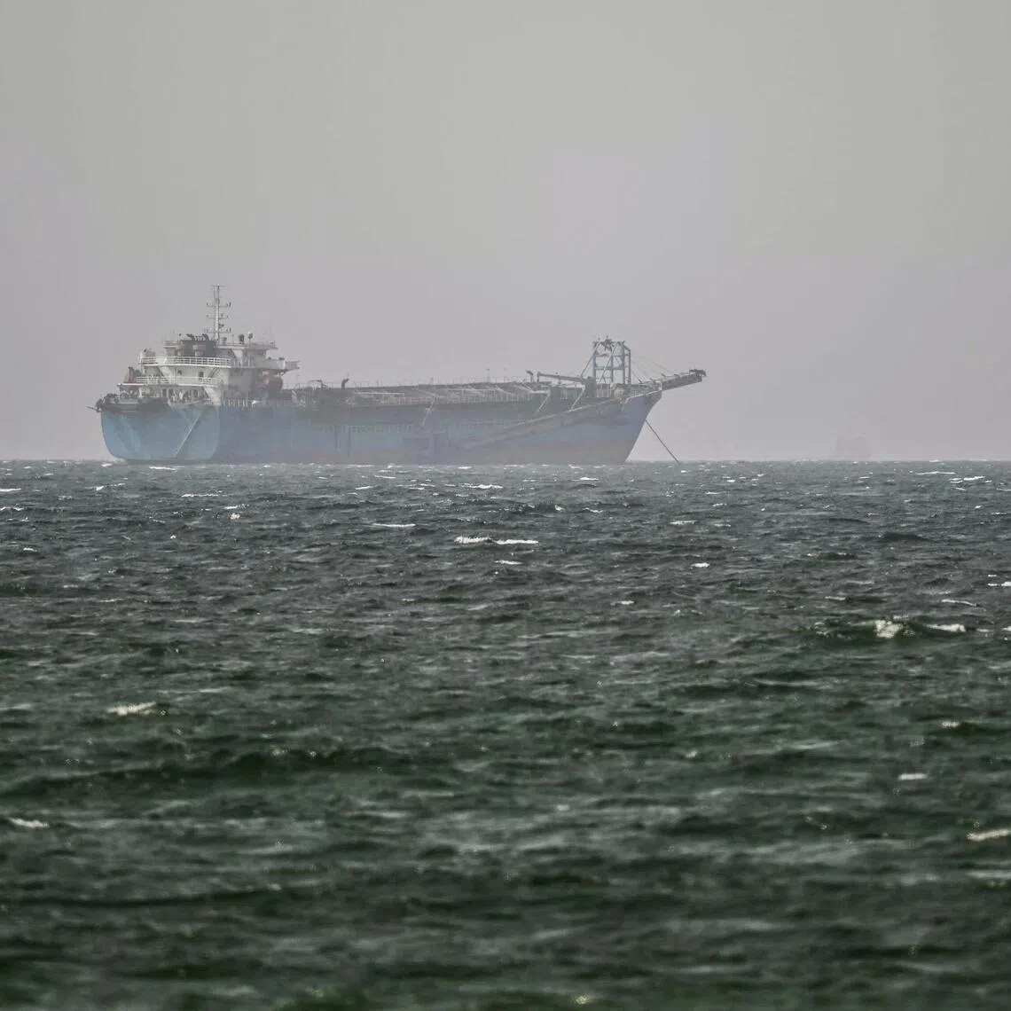 A vessel is anchored off the coast of Sharjah in the United Arab Emirates on August 3, 2026. Iran's foreign ministry said on August 3 there were currently no negotiations with the United States but talks were taking place with Oman on management of the strategic Strait of Hormuz. Iran has kept control of Hormuz since the outbreak of the war in the Middle East on February 28. (Photo by AFP) /