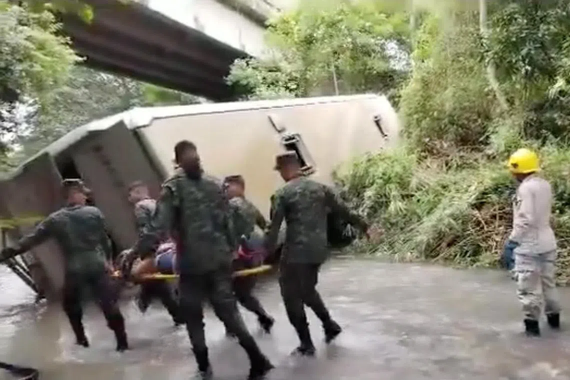 Soldiers carry a victim on a stretcher, after a bus fell into a ravine, near Tegucigalpa, in Honduras.   