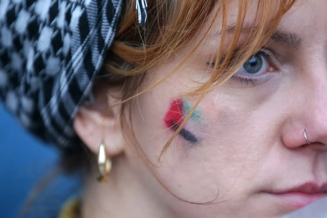 A woman with a Palestinian flag painted on her face during a rally in support of the Palestinian people in Belgrade, Serbia, on Oct 5, 2025. 