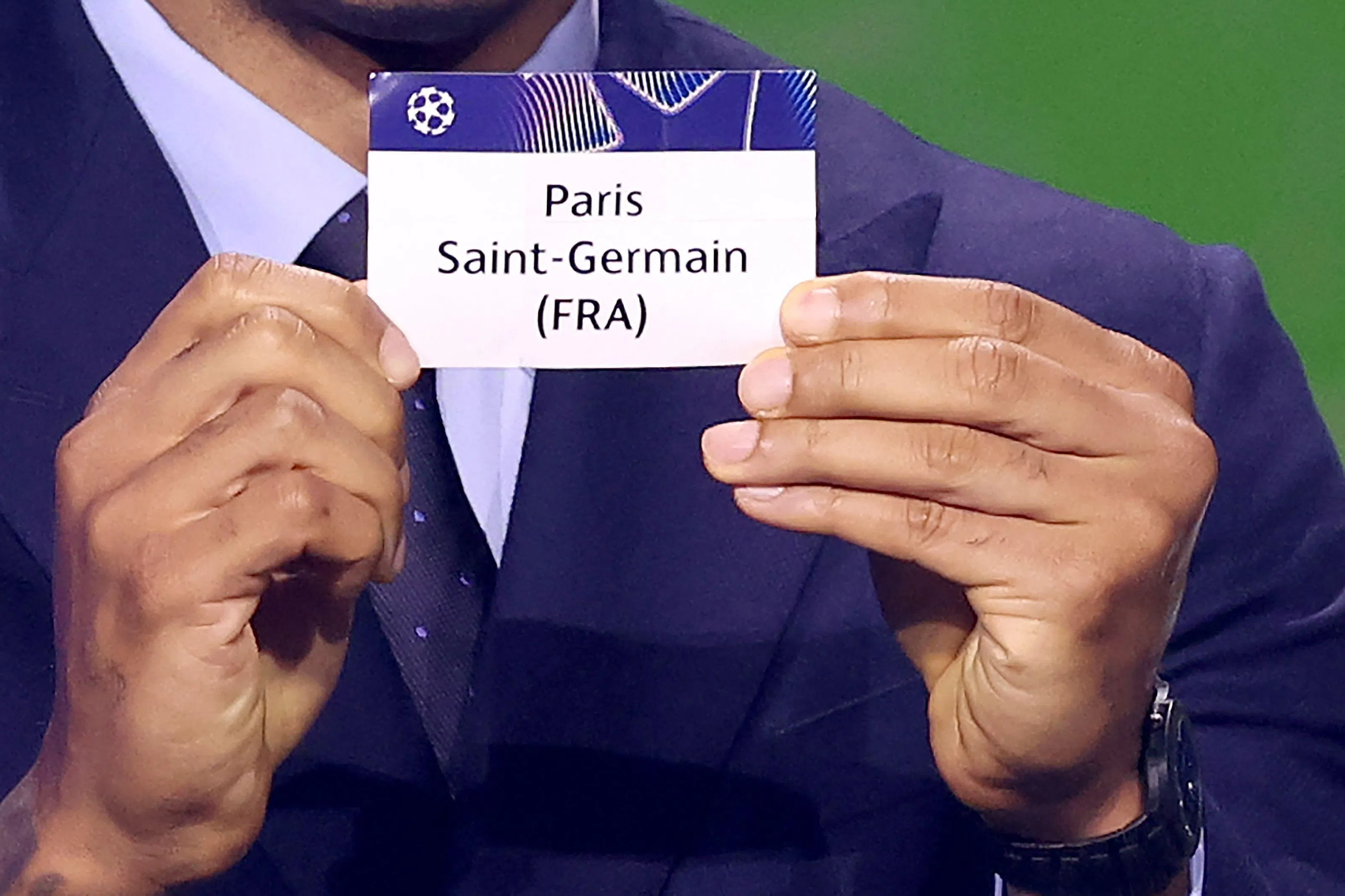 French former football player Thierry Henry shows the paper slip of Paris Saint-Germain (FRA) during the draw ceremony for the league phase of the 2026-2027 UEFA Champions League football tournament at the Grimaldi Forum in the Principality of Monaco on August 27, 2026. (Photo by Valery HACHE / AFP)