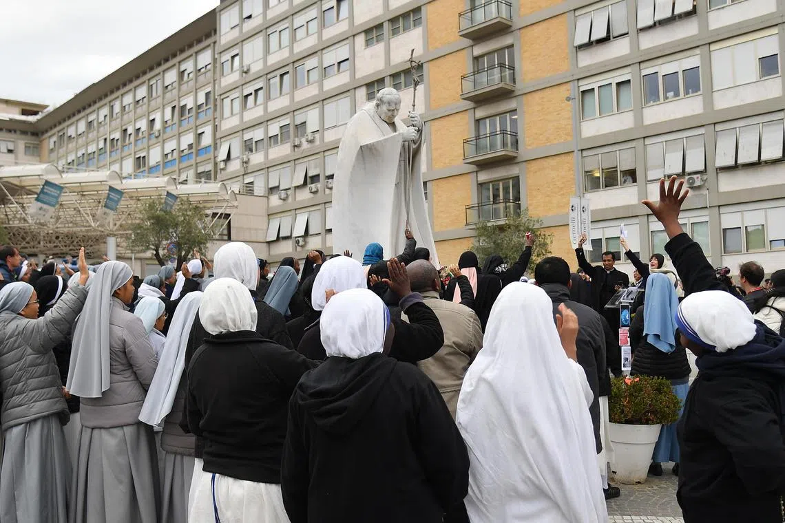 Catholics continue to gather at the Gemelli hospital to pray for Pope Francis or leave flowers, candles and cards. 
