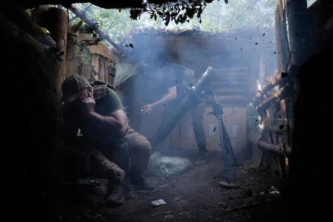Ukrainian soldiers fire a concealed mortar in Kupiansk, Ukraine, on May 25, 2025. 