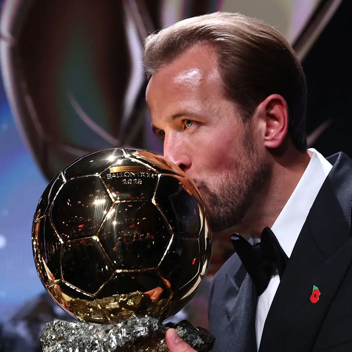 England and Bayern Munich forward Harry Kane celebrates after winning the Ballon d’Or award for best male footballer.