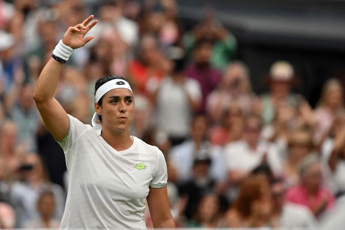 Tunisia's Ons Jabeur celebrates winning against Belarus' Aryna Sabalenka.