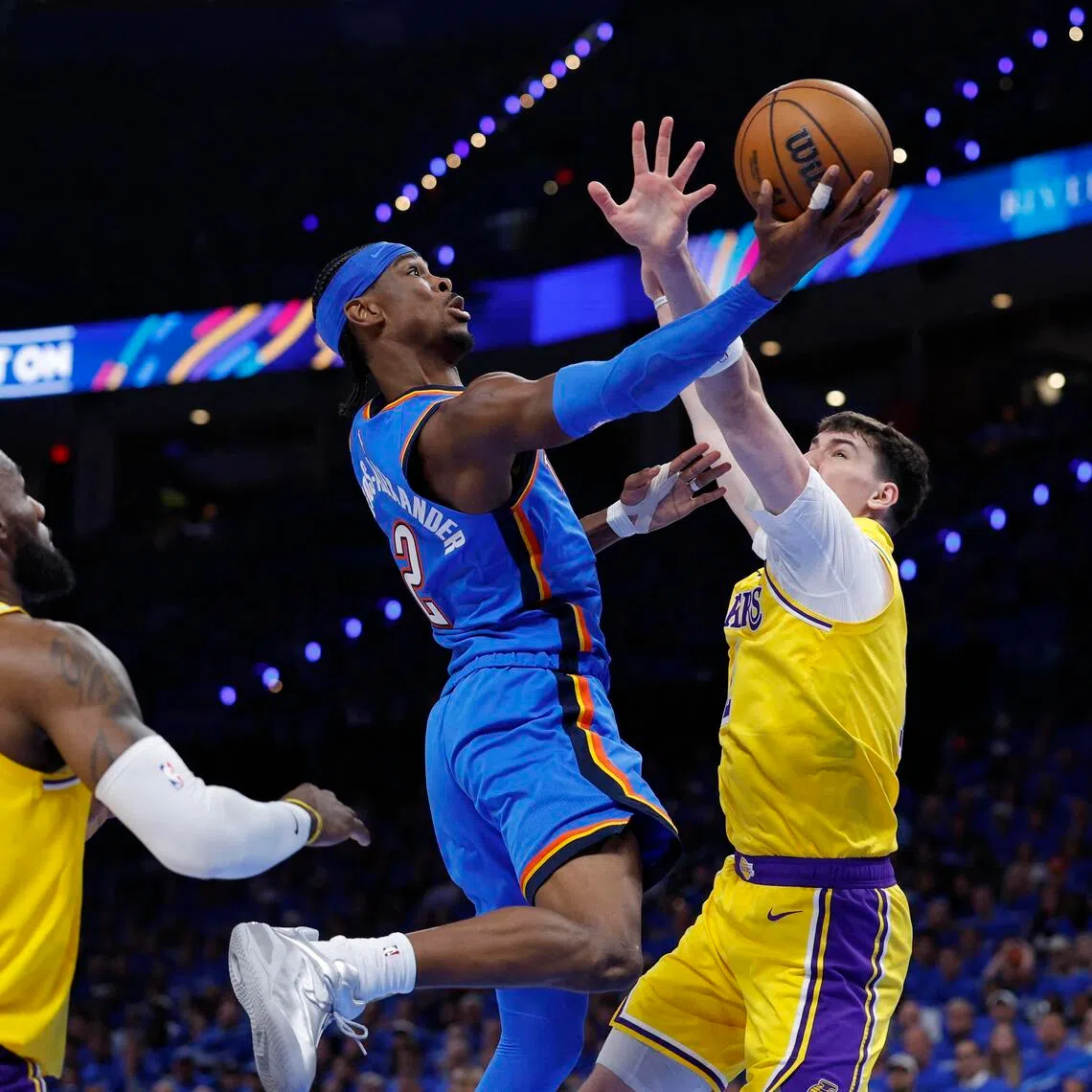 Oklahoma City Thunder guard Shai Gilgeous-Alexander goes up for a basket as Los Angeles Lakers forward Jake LaRavia defends in the second half during Game 1.