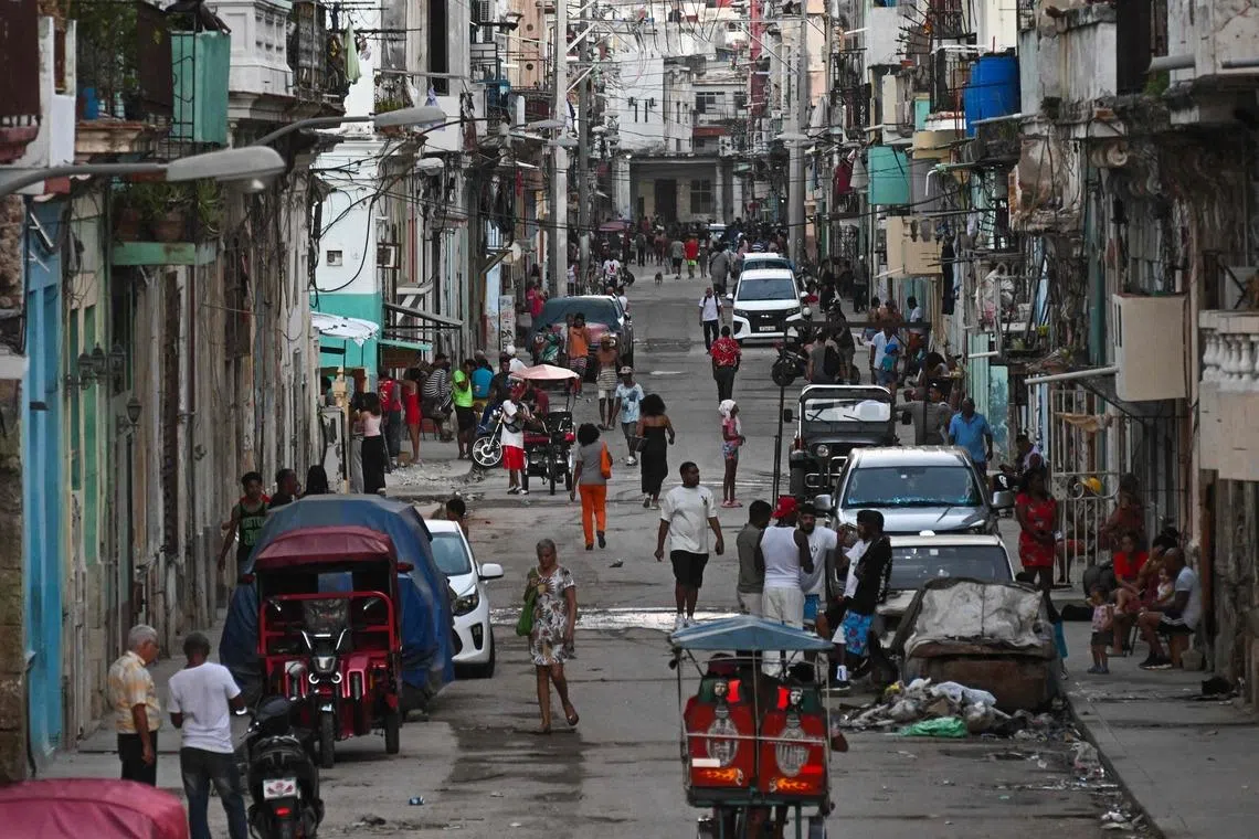 TOPSHOT - View of a street of Havana during a blackout on March 16, 2026. Cuba suffered a widespread power cut on March 16, 2026, according to the national electricity company, against the backdrop of a severe crisis on the island caused by the US energy blockade. (Photo by YAMIL LAGE / AFP)