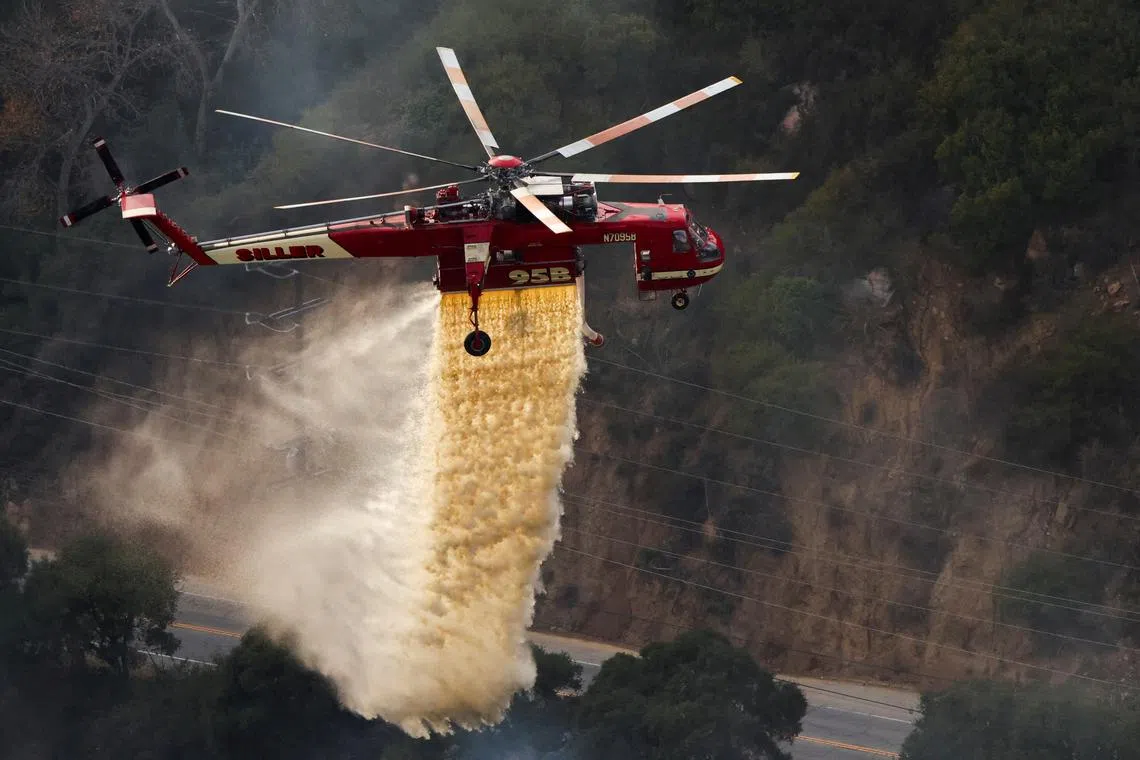 A helicopter battling the Franklin Fire in Malibu, California, U.S., Dec 11, 2024.