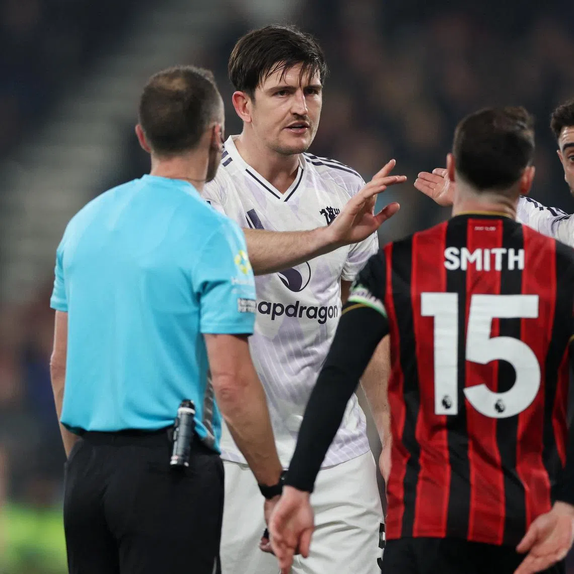Manchester United's Harry Maguire reacts with Bruno Fernandes after he is shown a red card by referee Stuart Attwell.