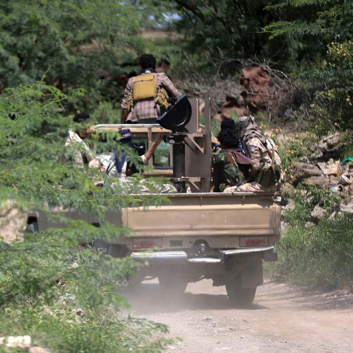 Saudi-backed Yemen government soldiers ride in a pick-up truck near the Jabal Han front, west of the city of Taiz, following fierce battles earlier in the day on Oct 3.