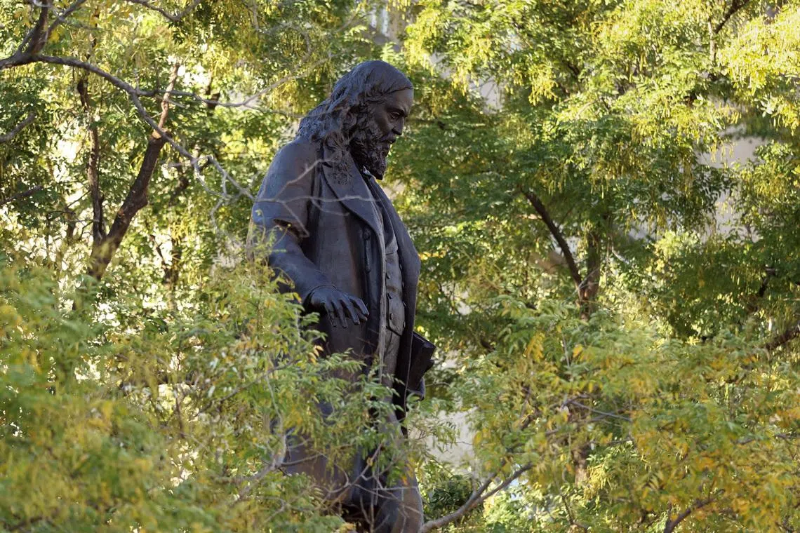 The bronze statue of Confederate Gen. Albert Pike, toppled by demonstrators in 2020, is seen through the trees after being reinstalled this past weekend, a result of U.S. President Donald Trump’s executive order \"Restoring truth and Sanity to American History\" in Washington, D.C., U.S., October 27, 2025. REUTERS/Kevin Lamarque