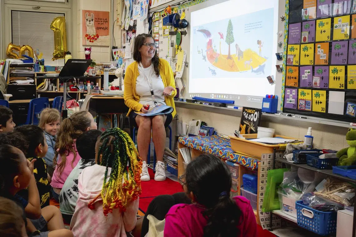 Michelle Liwacz reads her first grade class a book called ÒIf Sharks Disappeared,Ó at Slackwood Elementary in Lawrence Township, N.J. on May 31, 2023. New Jersey is the first state to require that climate change be taught at all grade levels. Rather than focus on doom and gloom, students are encouraged to problem solve. (Desiree Rios/The New York Times)