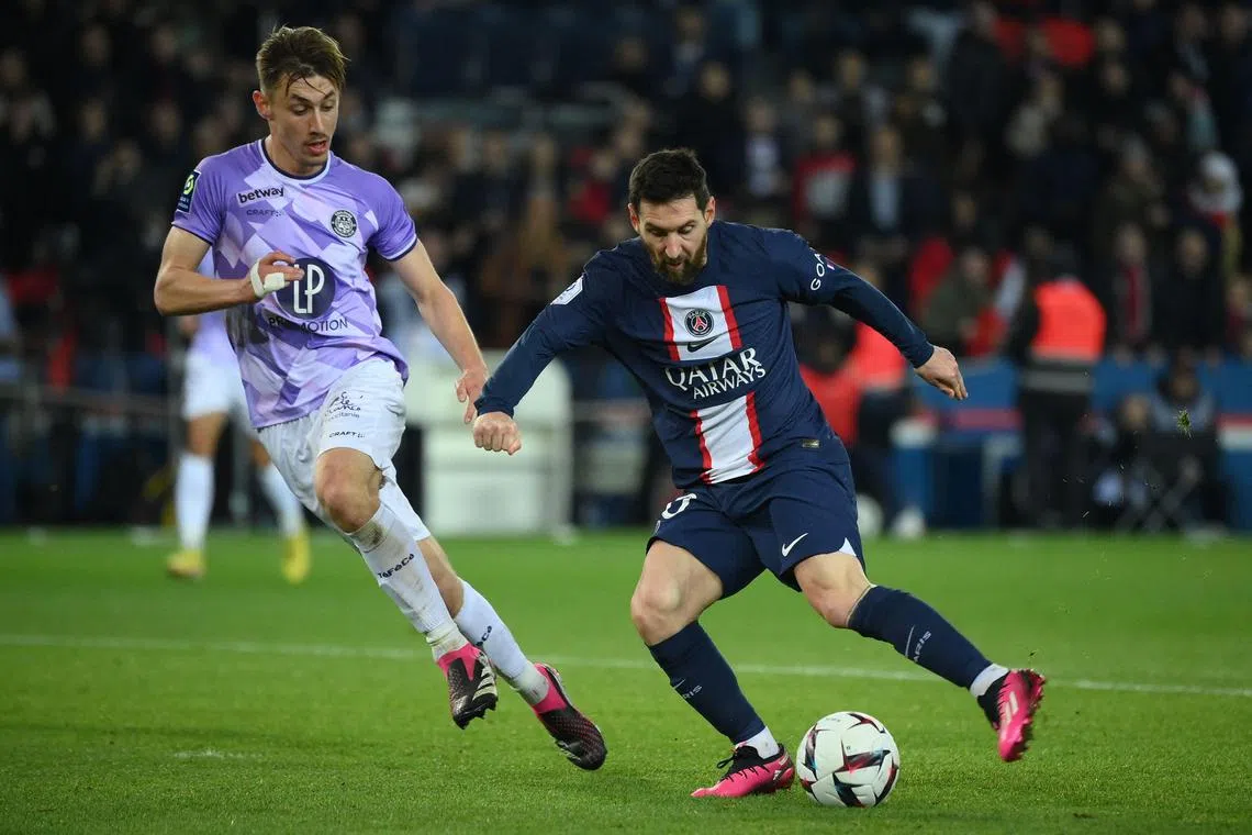 Paris Saint-Germain's Argentinian forward Lionel Messi tussling for the ball with Toulouse's French defender Anthony Rouault during the French Ligue 1 match on Saturday, which PSG won 2-1.