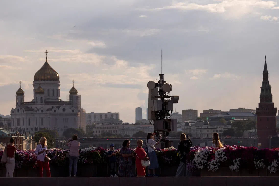 FILE PHOTO: People gather on a bridge with the view on Christ the Savior Cathedral, towers of the Kremlin and city’s skyline in Moscow, Russia, August 5, 2024. REUTERS/Maxim Shemetov/File Photo