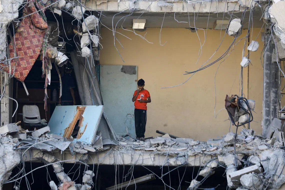 A Palestinian boy standing amid rubble, after Israeli forces withdrew from a part of Gaza City, on July 12.