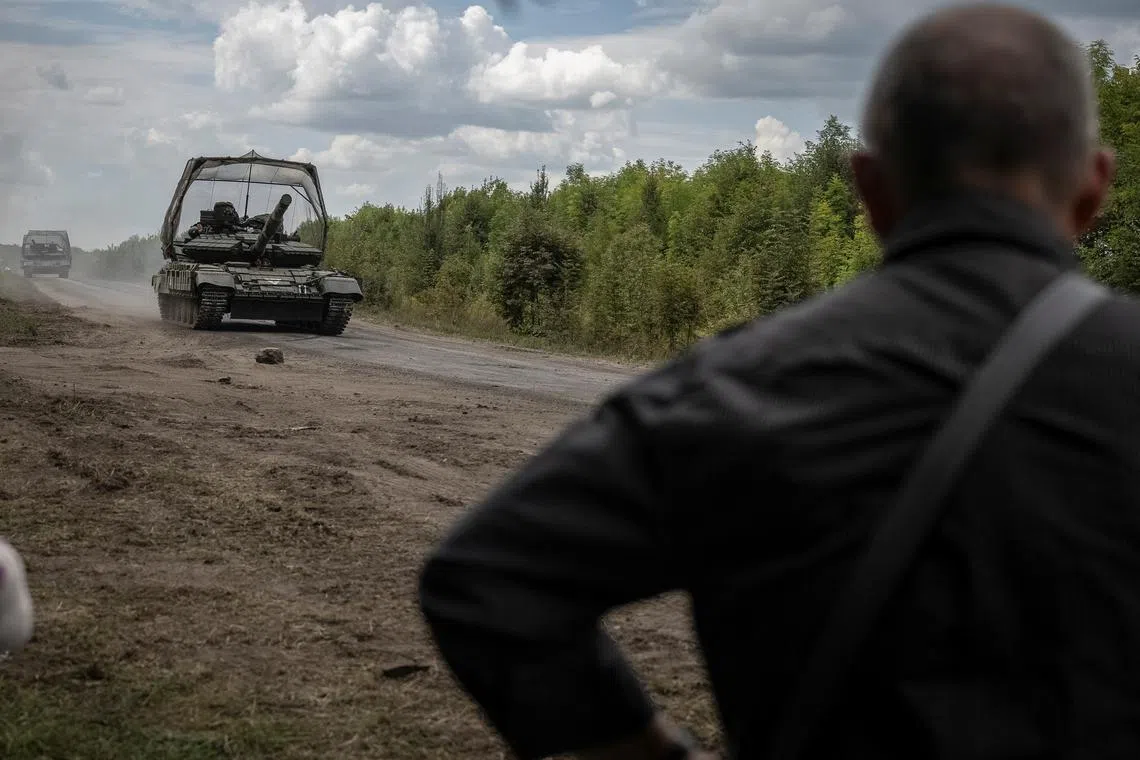 Ukrainian servicemen riding on tanks near the Russian border in northern Sumy region on Aug 10.