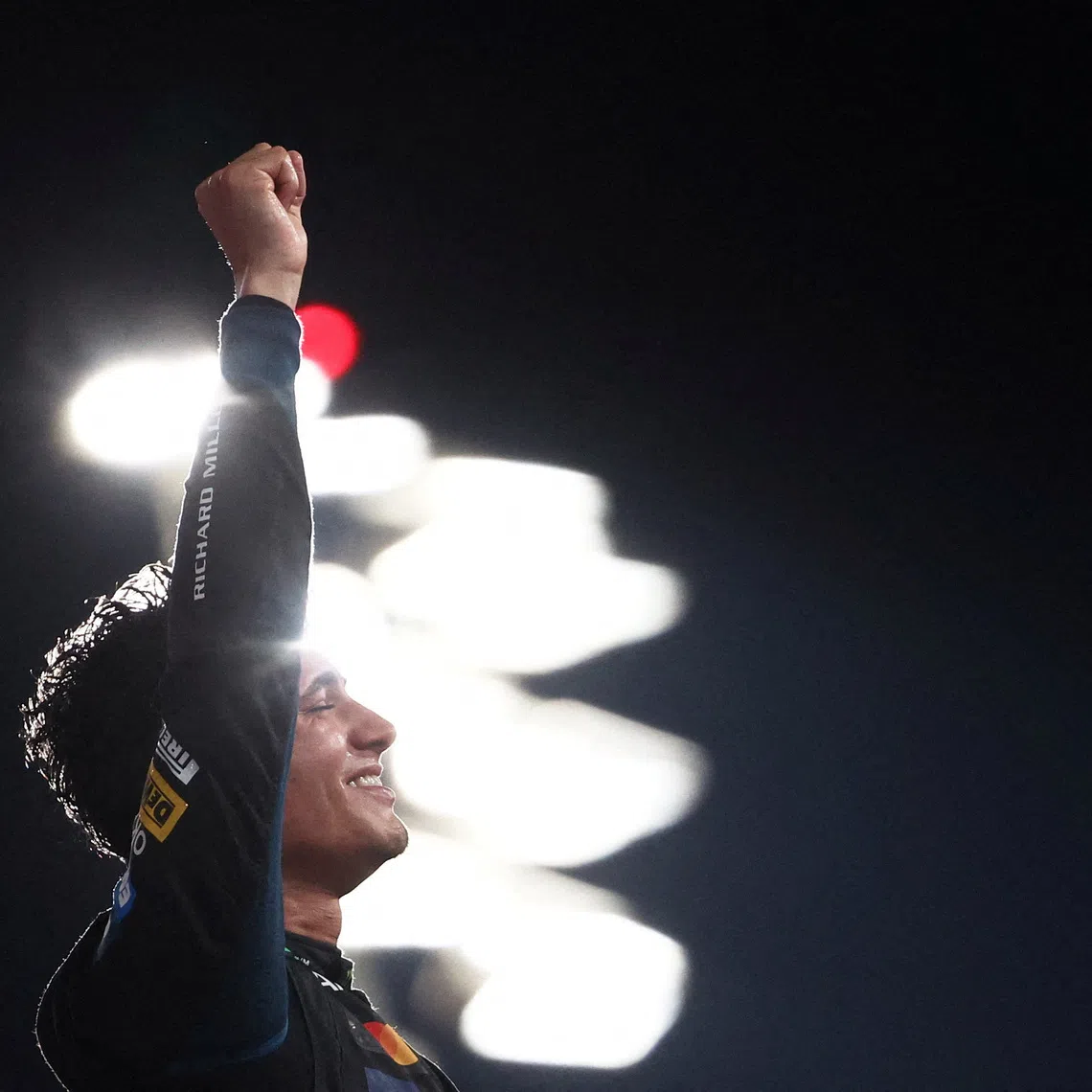 Formula One F1 - Abu Dhabi Grand Prix - Yas Marina Circuit, Abu Dhabi, United Arab Emirates - December 7, 2025 McLaren's Lando Norris celebrates on the podium after becoming the 2025 Formula One World Champion REUTERS/Jakub Porzycki