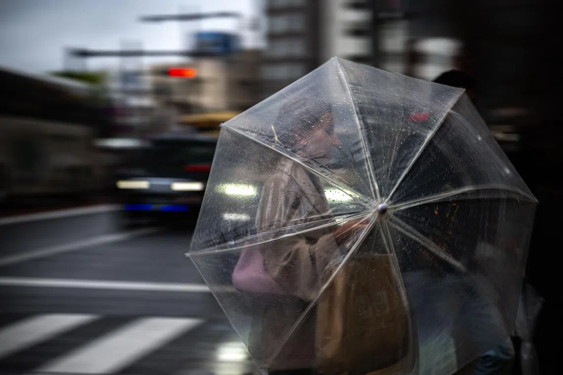 A woman walking in Asakusa district, a popular tourist location in Tokyo, during the last day of "Golden Week" holiday, on May 6, 2025. 