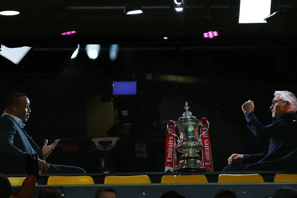 TV pundits and former players Paul Ince (left) and Gary Lineker are pictured with the FA Cup trophy during the broadcast of the third round match between Liverpool and Wolves on Tuesday. 