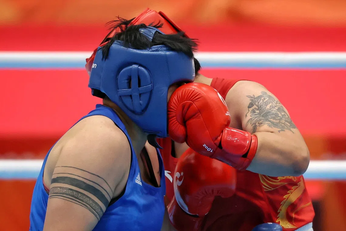 (FOR SPORTS FEATURE, PLEASE DO NOT SHARE) Bao Ziyi (in red) of China punching Luu Diem Quynh of Vietnam in the face during the Aichi-Nagoya 2026 Asian Games boxing women's 75kg semi-final at Nishio Gymnasium in Aichi, Japan on Sept 30, 2026. ST PHOTO: KEVIN LIM stpixgames05-ol stpixgames05