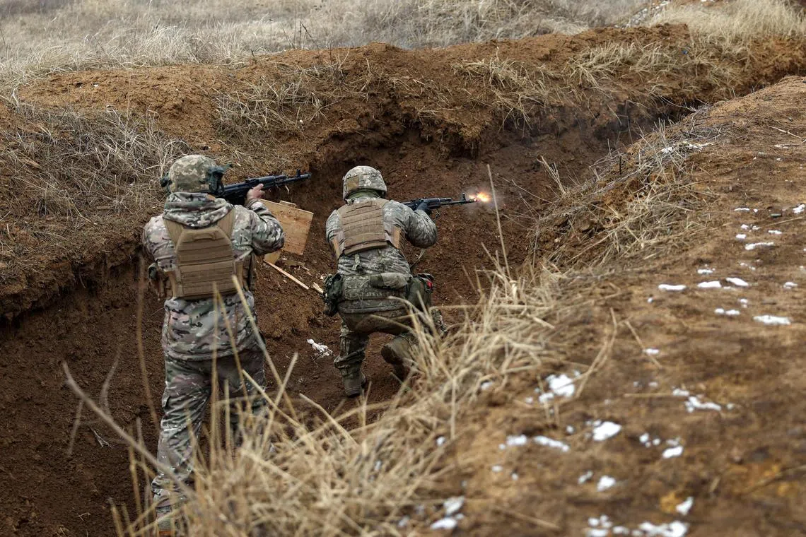 Ukrainian servicemen go through military training near the front line, in Ukraine's Donetsk region.