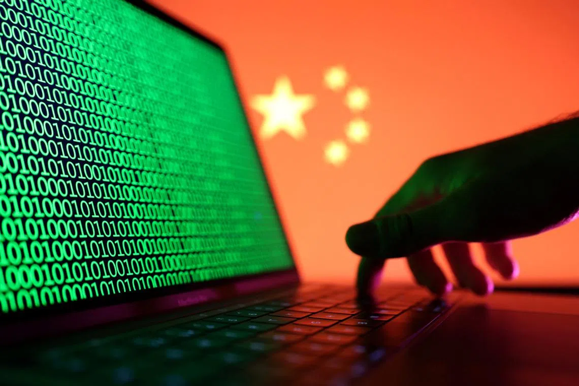 FILE PHOTO: A hand is seen on a laptop with binary codes displayed in front of the Chinese flag in this illustration taken, August 19, 2022. REUTERS/Dado Ruvic/Illustration/File Photo