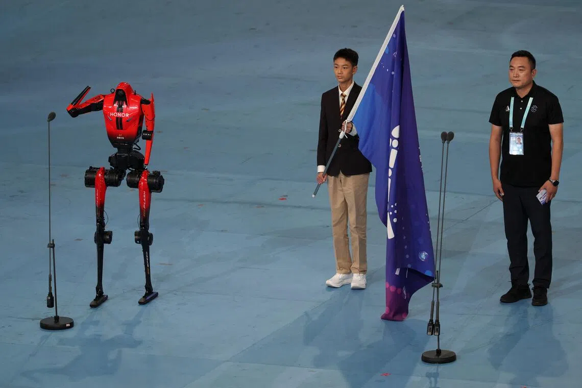 A Lightning humanoid robot by Honor takes an oath as a robot athlete representative during the opening ceremony for the second World Humanoid Robot Games in Beijing.