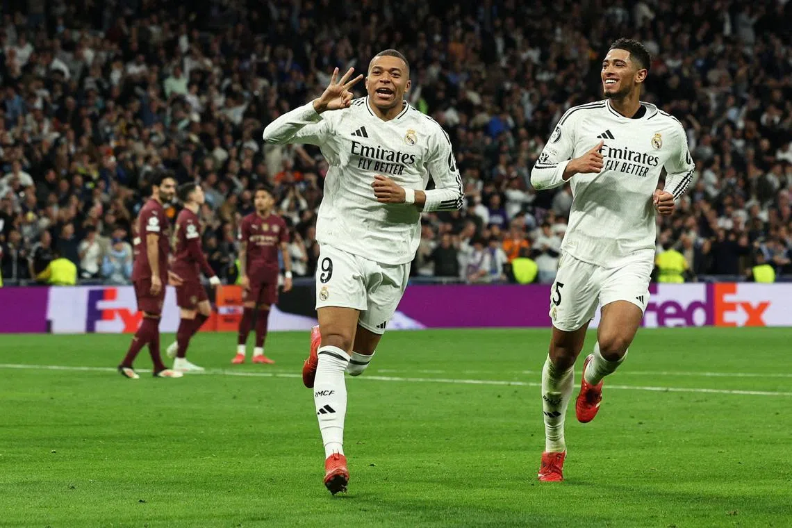 Real Madrid's Kylian Mbappe celebrates scoring their third goal to complete his hat-trick with Jude Bellingham.     