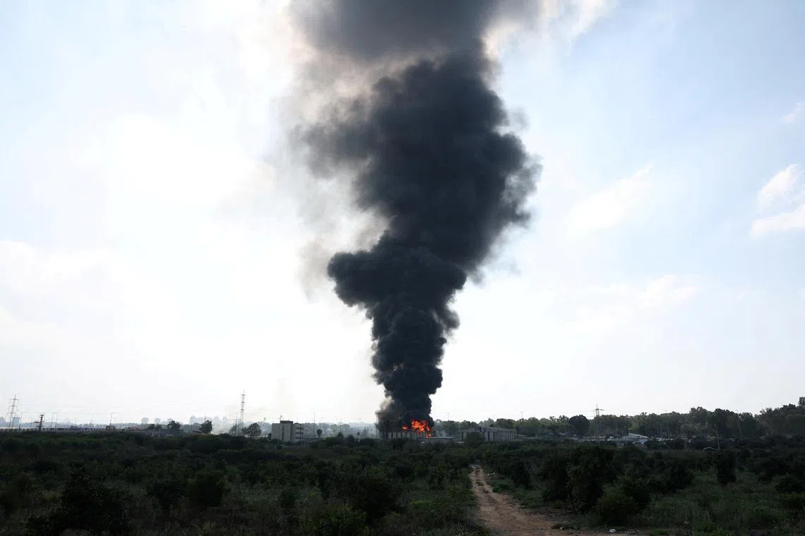 FILE PHOTO: Smoke rises from a fire following a missile attack from Iran, in Herzliya, Israel, June 17, 2025. REUTERS/Ronen Zvulun/File photo