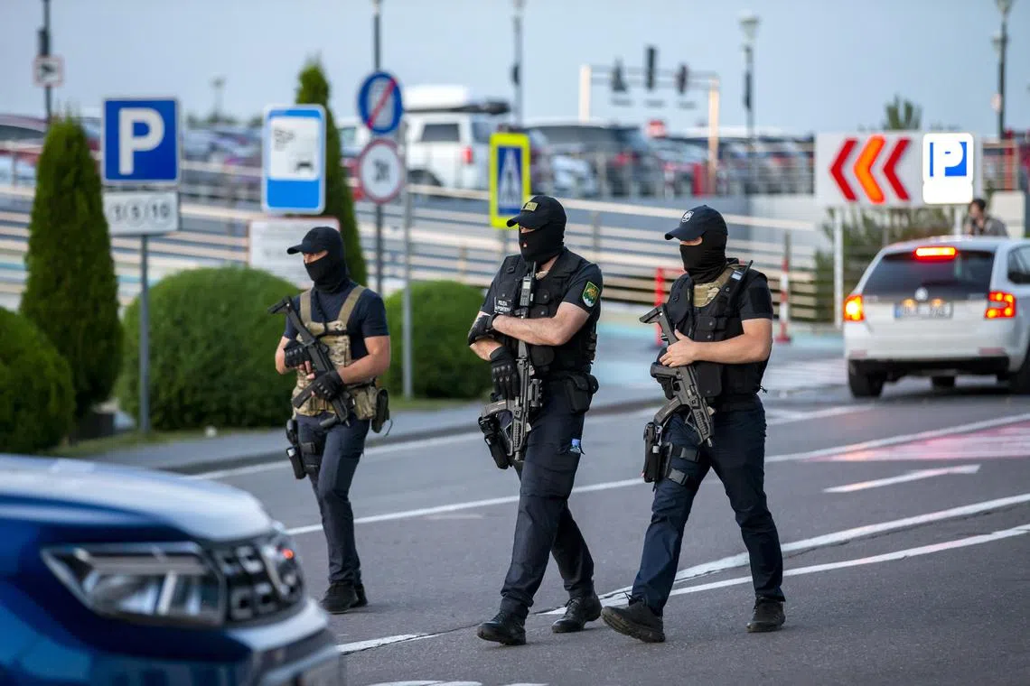 Armed special force officers patrol outside Chisinau International Airport in Moldova.