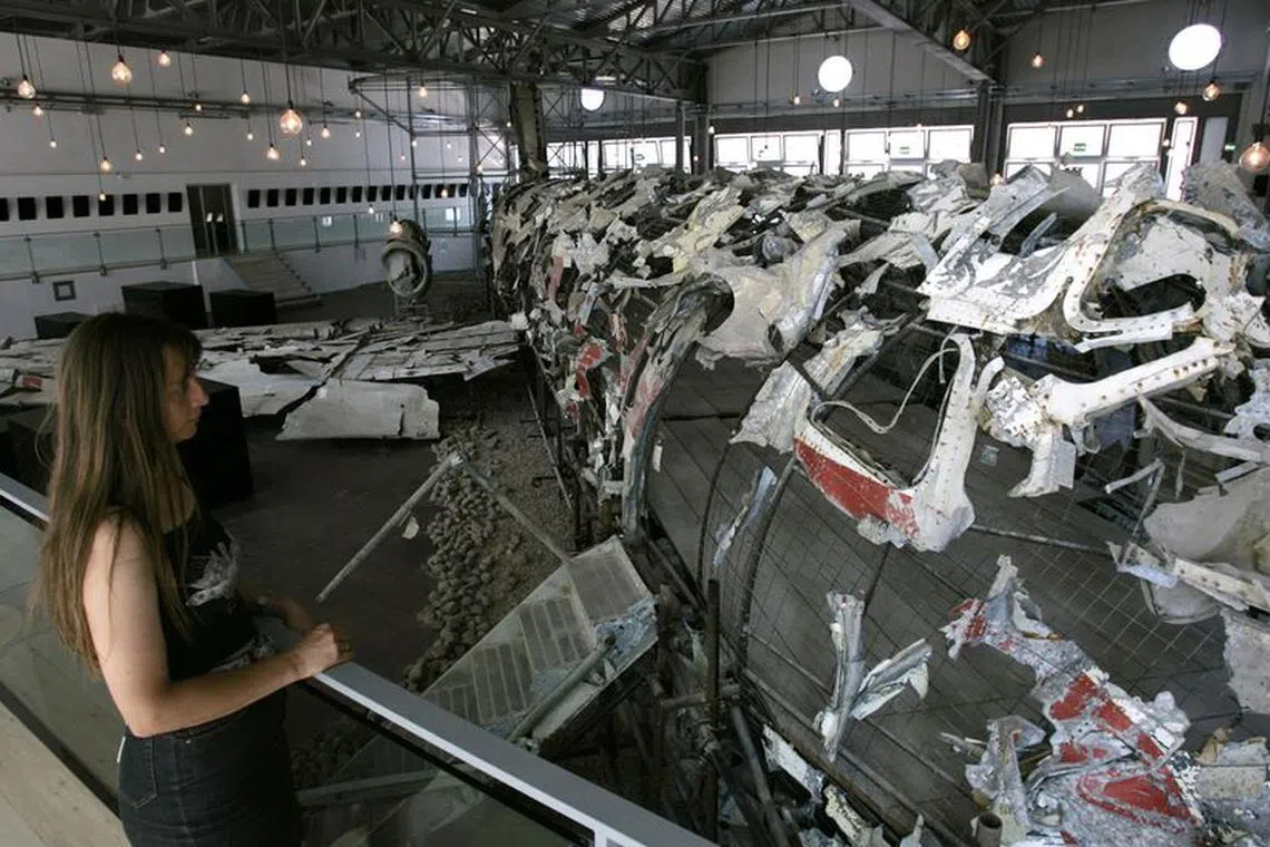 FILE PHOTO: A visitor to the 'Museum for the Memory of Ustica' views the carcass of a DC-9 airplane, created by French artist Christian Boltanski, in Bologna July 11, 2007. Two thousand steel fragments, painstakingly put together, is all that is left of a civilian airliner that mysteriously plunged into the waters off the Sicilian island of Ustica  on its way from Bologna to Palermo./File Photo