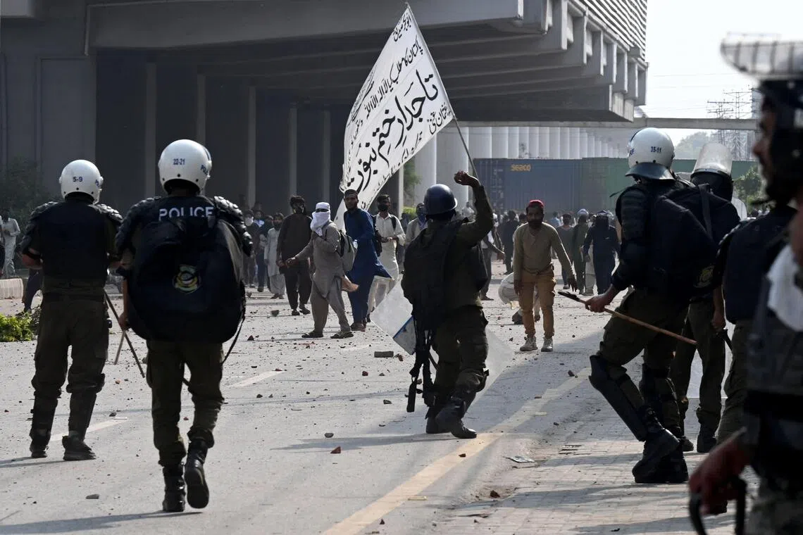 Tehreek-e-Labbaik Pakistan activists clashing with police in Lahore on Oct 10.