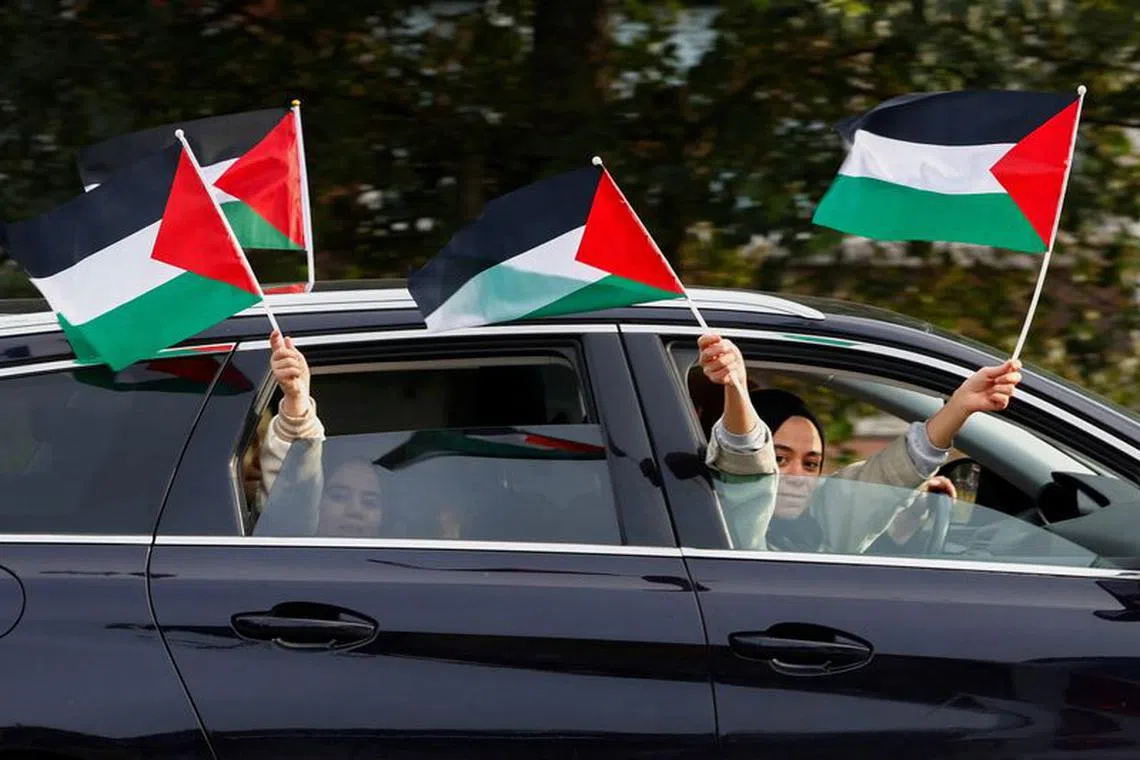 People protest in support of Palestinians in Gaza, from a car, as the conflict between Israel and Hamas continues, near the headquarters of the International Criminal Court (ICC), which has ongoing investigations into potential atrocity crimes carried out by Hamas in Israel, and by Israelis in the Gaza Strip going back to 2014, and which also covers the current conflict, in The Hague, Netherlands October 18, 2023. REUTERS/Piroschka van de Wouw
