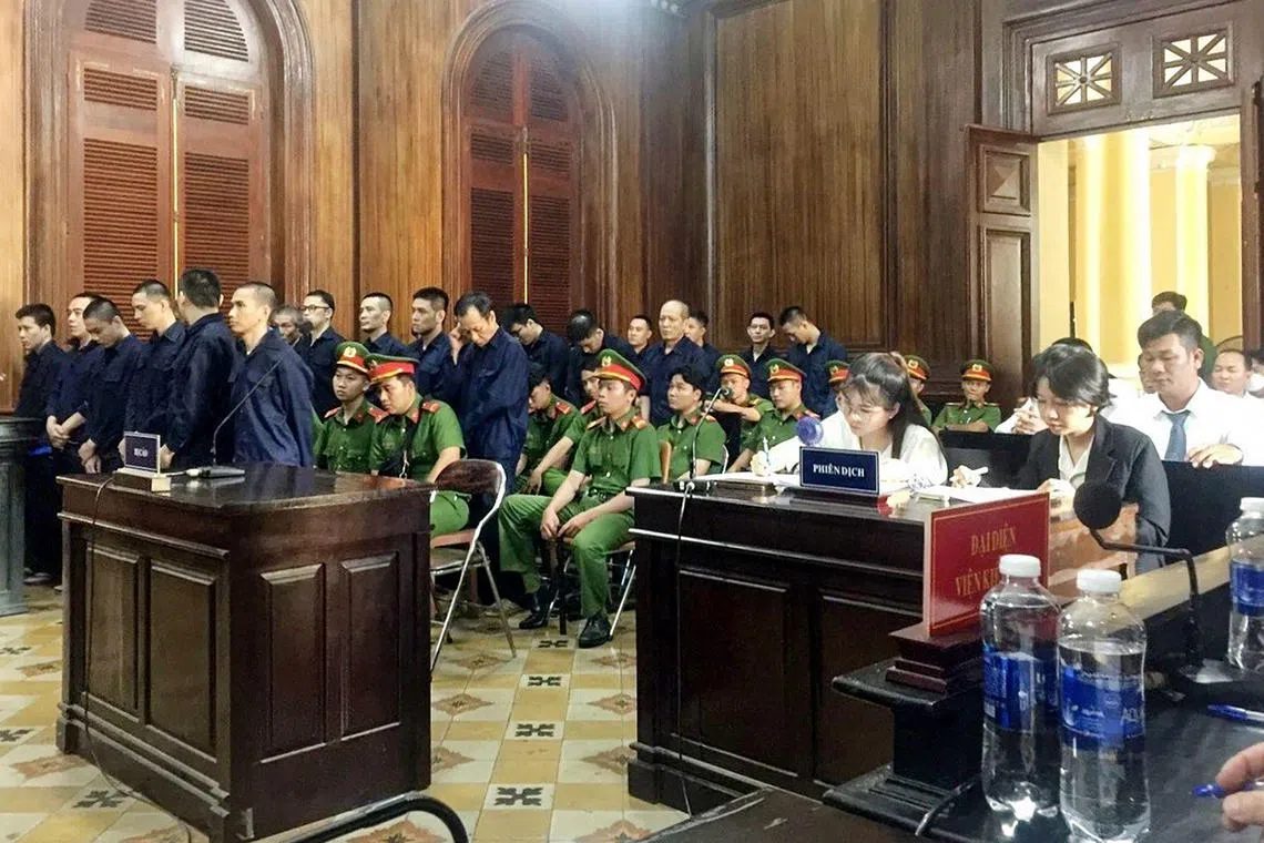 This photo released by the Vietnam News Agency (VNA) on November 12, 2023 shows defendants (L, in blue) standing during their trial for drug trafficking in Ho Chi Minh. Two South Koreans were among 18 people sentenced to death on drug smuggling and trafficking charges in Vietnam, state media said on November 12, 2023. (Photo by Vietnam News Agency / AFP)