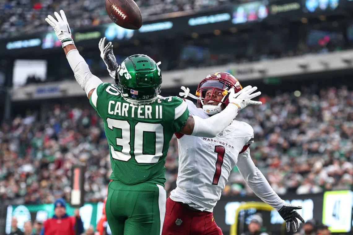 FILE PHOTO: Dec 24, 2023; East Rutherford, New Jersey, USA; New York Jets cornerback Michael Carter II (30) breaks up a pass intended for Washington Commanders wide receiver Jahan Dotson (1) during the second half at MetLife Stadium. Mandatory Credit: Vincent Carchietta-USA TODAY Sports/File Photo